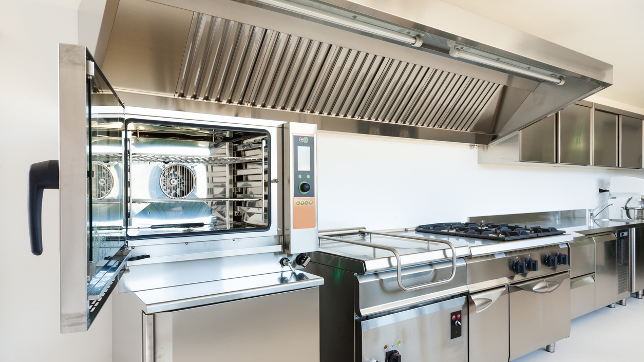 Professional commercial kitchen with stainless steel hood ventilation system